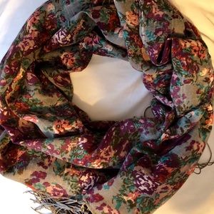 Fringed gray scarf with jewel tone florals.